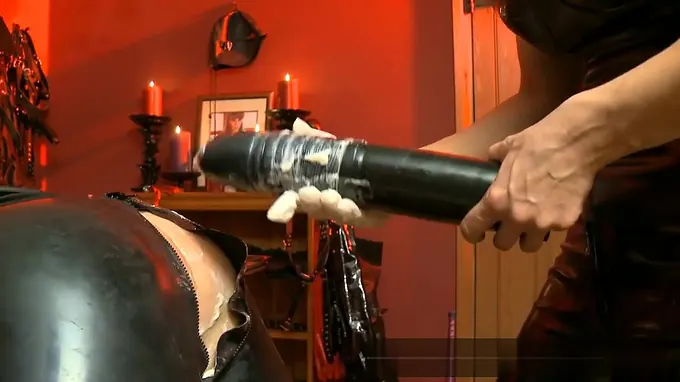 Horny slut covers dildo with cream and slides it inside anal hole