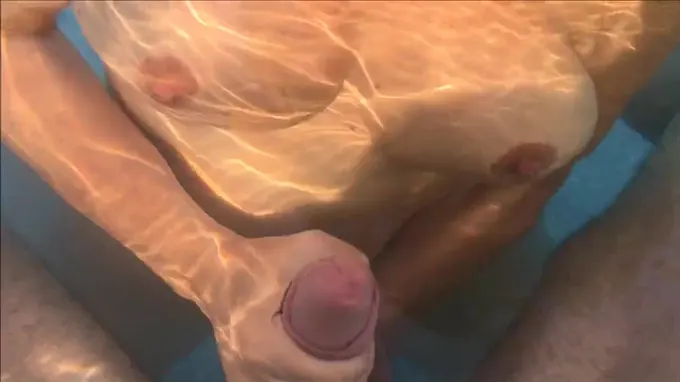 Horny naked babe giving him a hand job in the pool and gets cum covered