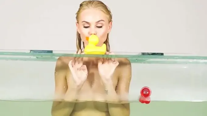 Teen blonde babe is under water stimulating her shaved pussy hole