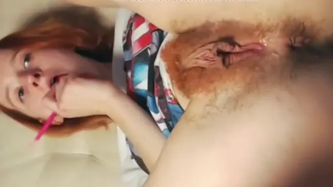 Red haired girl flashing her hairy pussy and masturbates on porn video
