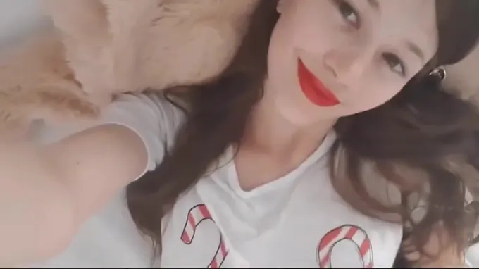 Innocent teen babe staring into camera while fingering her pussy