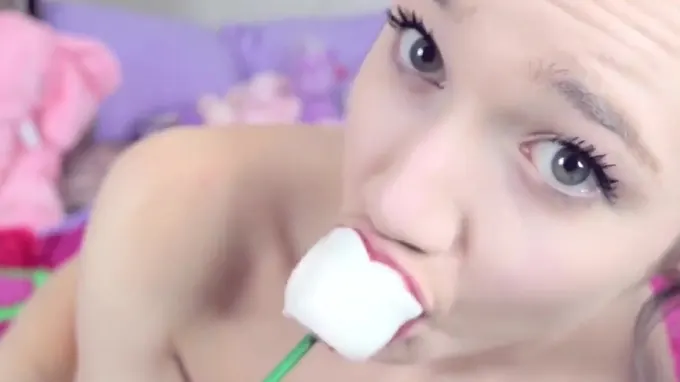 Naked beautiful babe eating a candy and masturbating her pussy