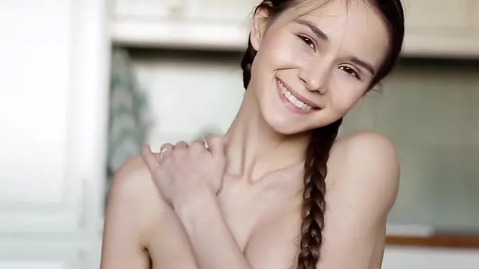 Skinny and perky teen is in the kitchen touching herself seductively