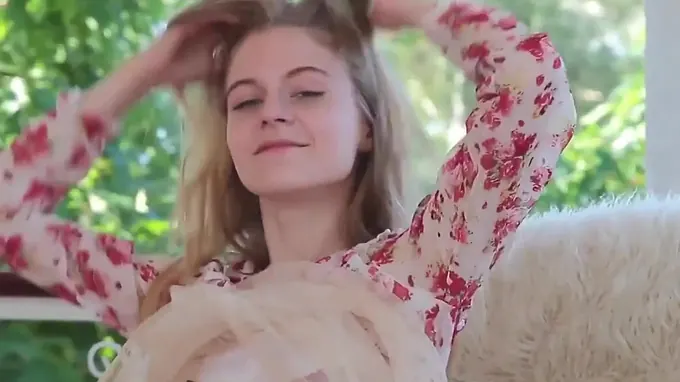 Teen beauty is walking outdoors in her seductive dress posing naughty