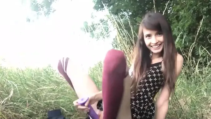 Cute skinny girl bates her tiny pussy outdoor sucking a long dildo