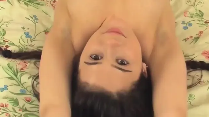 Kinky naked brunette poses on bed flashing her shaved pussy hole