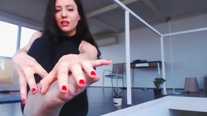 Horny brunette is posing on the floor stretching out her fine body