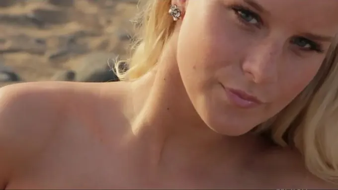 Stunning blond babe is getting naked in the desert showing her boobs