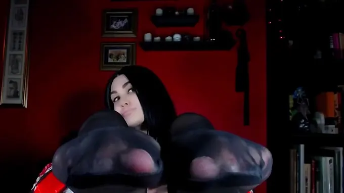 Sexy girl exposes her nylon feet and is taking off her tights