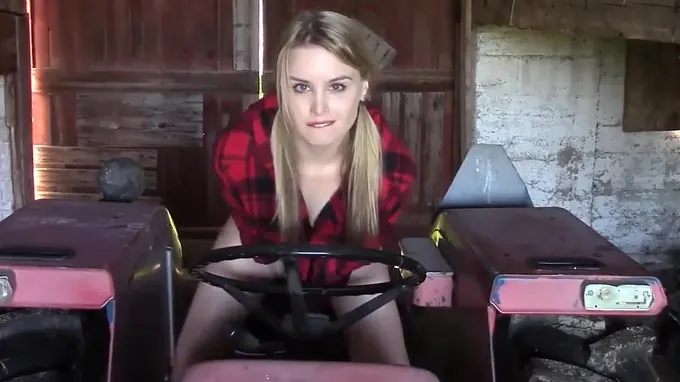 Sexy girl is masturbating on the tractor pleasuring her shaved pussy hole