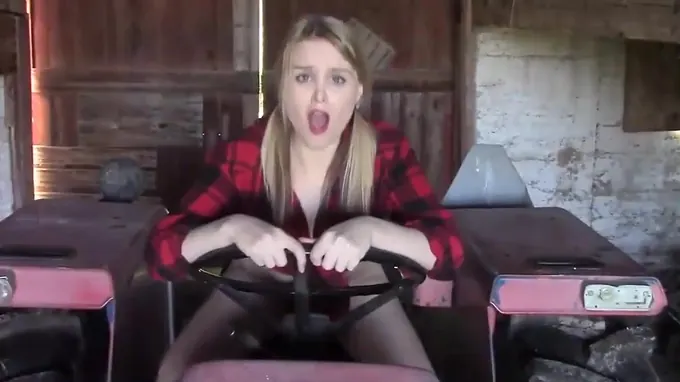 Sexy girl is masturbating on the tractor pleasuring her shaved pussy hole