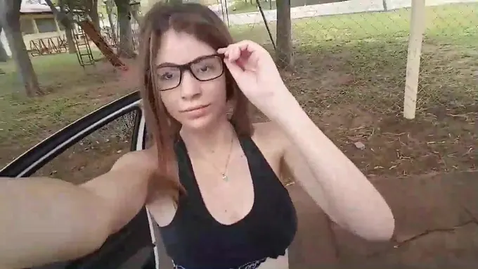 Teen babe is driving a car and flashes her small natural boobs