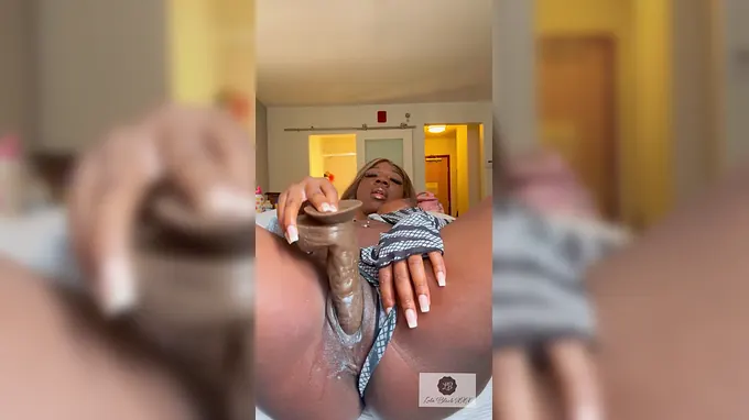 Lola Dark-hued X X X's slender assets juggles in sheer pleasure as she delectations herself with a massive fuck stick